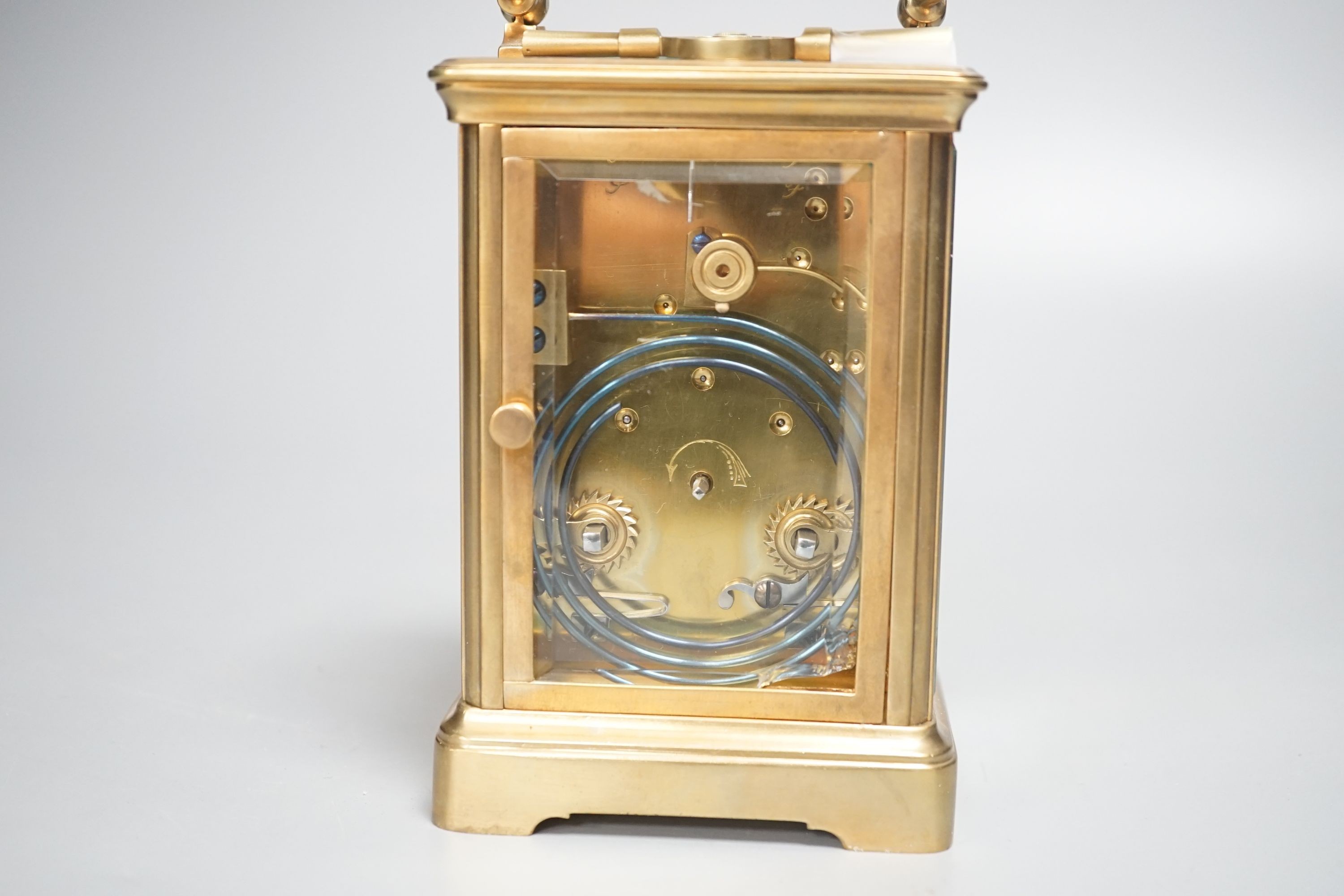 A brass repeating carriage clock, 13cm with key